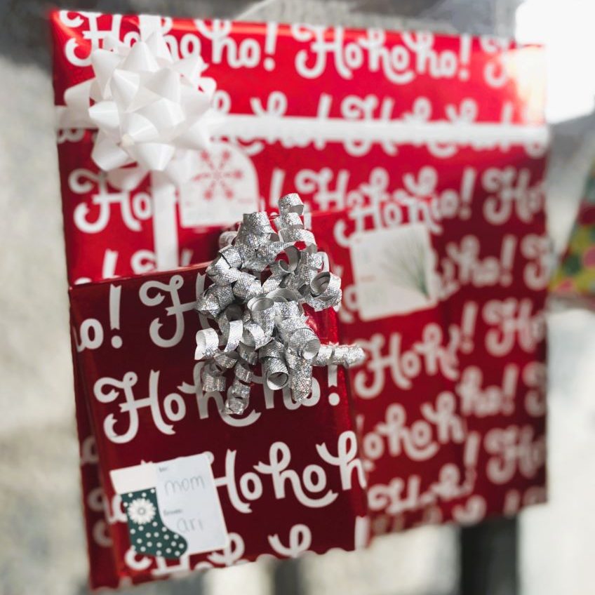 Christmas gifts wrapped in red wrapping paper