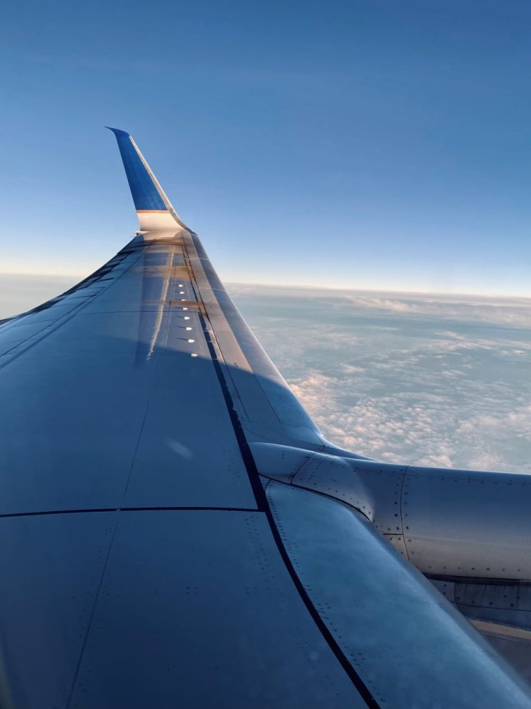 Sky view from inside airplane to inspire gifts for traveler lovers.